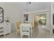 Bright dining area features sliding glass doors and a modern light fixture at 334 Shiloh Ct, The Villages, FL 32162