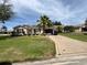 Inviting single-story home featuring a lush green lawn and a welcoming driveway at 334 Shiloh Ct, The Villages, FL 32162