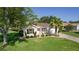 Charming single-story home with a well-manicured lawn, decorative driveway, and a lovely palm tree at 334 Shiloh Ct, The Villages, FL 32162