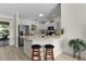 Bright kitchen and breakfast bar with stainless steel appliances and modern finishes at 334 Shiloh Ct, The Villages, FL 32162