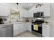 Well-lit kitchen featuring stainless steel appliances and white cabinetry at 334 Shiloh Ct, The Villages, FL 32162