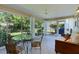 Bright lanai with tile flooring features large windows overlooking a beautifully landscaped backyard at 334 Shiloh Ct, The Villages, FL 32162