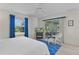 Bright main bedroom featuring sliding glass doors and a serene backyard view at 334 Shiloh Ct, The Villages, FL 32162