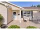 Inviting front porch with seating offers a cozy spot, complemented by neat landscaping and classic home architecture at 334 Shiloh Ct, The Villages, FL 32162