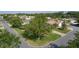 An aerial view of the neighborhood street showing trees, lawns and neighboring houses at 334 Shiloh Ct, The Villages, FL 32162