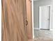 Stylish weathered wood barn door adds a rustic touch and saves space at 3638 Sw 127Th Lane Rd, Ocala, FL 34473