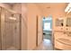 Bright bathroom featuring a walk-in shower with tile surround and double sink vanity at 3638 Sw 127Th Lane Rd, Ocala, FL 34473