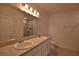Well-lit bathroom with double sinks, and vanity, and a glass door shower at 3638 Sw 127Th Lane Rd, Ocala, FL 34473