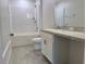 Bathroom features a shower-tub combination with white subway tiles, vanity, and modern fixtures at 3638 Sw 127Th Lane Rd, Ocala, FL 34473