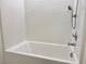 Clean, white bathtub with modern fixtures and a shower head at 3638 Sw 127Th Lane Rd, Ocala, FL 34473