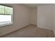 Neutral bedroom with carpet and a large window, offering serene and simple space at 3638 Sw 127Th Lane Rd, Ocala, FL 34473