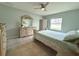 Serene bedroom featuring light green walls, a ceiling fan, and a coordinating dresser and bedding at 3638 Sw 127Th Lane Rd, Ocala, FL 34473