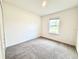 Bright bedroom with neutral carpet, window, and ample space at 3638 Sw 127Th Lane Rd, Ocala, FL 34473