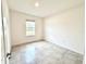 Bright bedroom with tile flooring, neutral paint, and a window view at 3638 Sw 127Th Lane Rd, Ocala, FL 34473