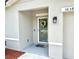 Charming front door with decorative wreath and gray-painted exterior at 3638 Sw 127Th Lane Rd, Ocala, FL 34473