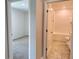Hallway showcasing access to a bedroom with carpet and a bathroom with a shower-tub combo at 3638 Sw 127Th Lane Rd, Ocala, FL 34473