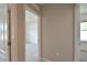 Hallway showcases neutral paint, tile flooring, and access to several rooms in the home at 3638 Sw 127Th Lane Rd, Ocala, FL 34473