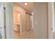 Hallway with barn door to bedroom and an open door to the bathroom vanity at 3638 Sw 127Th Lane Rd, Ocala, FL 34473