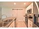 Contemporary kitchen with granite countertops, modern appliances and a stylish sliding barn door at 3638 Sw 127Th Lane Rd, Ocala, FL 34473