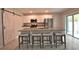 Stylish kitchen with a granite island, bar stool seating and white cabinetry at 3638 Sw 127Th Lane Rd, Ocala, FL 34473