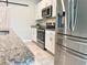 Well-lit kitchen with stainless steel appliances, granite countertops, and white cabinetry at 3638 Sw 127Th Lane Rd, Ocala, FL 34473