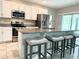 Bright kitchen offers stainless appliances, a breakfast bar with seating, and sliding door access to lanai at 3638 Sw 127Th Lane Rd, Ocala, FL 34473