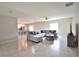 Open-concept living room showcasing a large sectional and kitchen with counter seating at 3638 Sw 127Th Lane Rd, Ocala, FL 34473