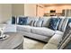 Comfortable living room featuring a large sectional sofa, stylish throw pillows, and modern décor at 3638 Sw 127Th Lane Rd, Ocala, FL 34473