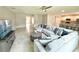 Bright living room boasts a plush sectional sofa and a modern ceiling fan overlooking the adjacent kitchen at 3638 Sw 127Th Lane Rd, Ocala, FL 34473