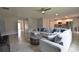Open-concept living room featuring modern furnishings, tiled floors, and a view of the kitchen at 3638 Sw 127Th Lane Rd, Ocala, FL 34473