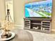 Comfortable living room featuring a large TV, stylish furniture, and access to hallway at 3638 Sw 127Th Lane Rd, Ocala, FL 34473