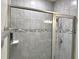 Modern bathroom featuring a tiled shower with glass door and updated fixtures at 3638 Sw 127Th Lane Rd, Ocala, FL 34473