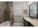 Well-lit bathroom with a marble sink, shower with floral curtain, and a large framed mirror at 40050 Darlington Ave, Lady Lake, FL 32159
