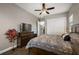 Comfortable bedroom featuring a ceiling fan, hardwood floors, and closet with sliding doors at 40050 Darlington Ave, Lady Lake, FL 32159