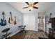 Cozy bedroom featuring musical instruments, modern ceiling fan, and a closet with panel doors at 40050 Darlington Ave, Lady Lake, FL 32159