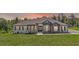 Charming single-story home with stone accents, arched windows, double doors, and a well-manicured lawn at 40050 Darlington Ave, Lady Lake, FL 32159
