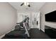 Bright home gym with treadmill and elliptical; leads to interiors of the home at 40050 Darlington Ave, Lady Lake, FL 32159
