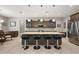 Kitchen island with pendant lighting, seating, stainless steel appliances, and custom cabinets at 40050 Darlington Ave, Lady Lake, FL 32159