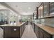 Bright, open kitchen with large island, stainless steel appliances, and seamless access to dining area at 40050 Darlington Ave, Lady Lake, FL 32159