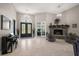 Open-concept living room with high ceilings, fireplace, tile floors, and large windows for natural light at 40050 Darlington Ave, Lady Lake, FL 32159