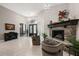Bright living room featuring a stone fireplace, tile flooring, and elegant furnishings at 40050 Darlington Ave, Lady Lake, FL 32159