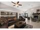 Elegant living room with a fireplace, tile floors, and an open view of the kitchen at 40050 Darlington Ave, Lady Lake, FL 32159