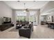 Open-concept living room with high ceilings, tile floors, and access to the kitchen and dining area at 40050 Darlington Ave, Lady Lake, FL 32159