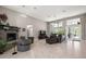 Open living room with a fireplace, tile flooring, high ceilings, and access to outdoor views at 40050 Darlington Ave, Lady Lake, FL 32159