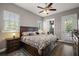 Main bedroom featuring a ceiling fan, and access to the bathroom and backyard at 40050 Darlington Ave, Lady Lake, FL 32159