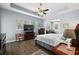 Spacious main bedroom features tray ceilings, large windows, ceiling fan, and view into a sitting area at 40050 Darlington Ave, Lady Lake, FL 32159