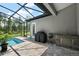 Outdoor living space featuring a private pool, screened enclosure, and built-in grilling area at 40050 Darlington Ave, Lady Lake, FL 32159