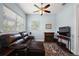 Sitting area features a leather recliner, fireplace, flat screen tv, and large windows at 40050 Darlington Ave, Lady Lake, FL 32159