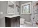 Bathroom with a dark brown vanity, white countertop, framed mirror, and a floral shower curtain at 506 Perkins St, Leesburg, FL 34748
