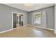 Cozy bedroom with a sliding glass door, neutral walls, and ample natural light at 506 Perkins St, Leesburg, FL 34748